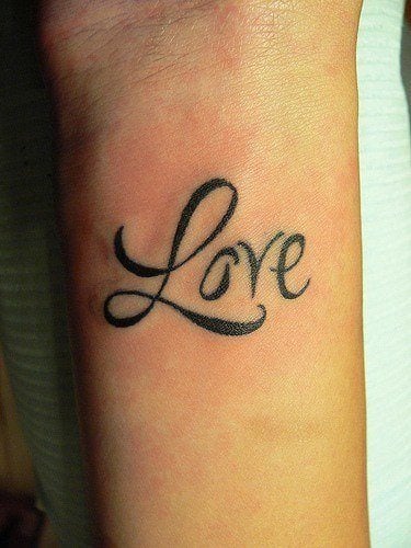 The word love is tattooed onto this girl's wrist in a clear but fancy ...