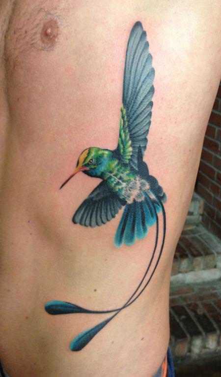 This hummingbird tattoo design has extra tail feathers to create a
