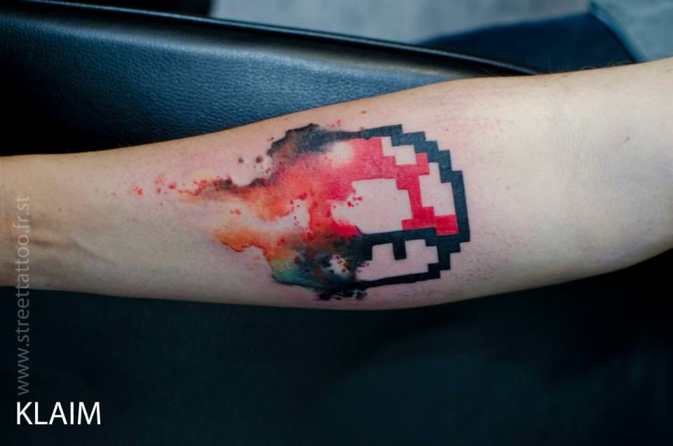 French tattoo arist KLAIM gives a mushroom from the Mario Bros video