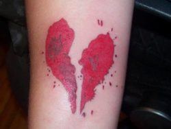 A tattoo of the blood spatter broken heart graphic from the movie Sweeney Todd