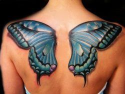A tattoo of blue butterfly wings across the back and shoulders is a symbol of freedom, beauty and change