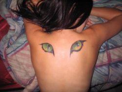 A tattoo of cats eyes on the back can be a symbol of the watchful, protective eyes of the Egyptian cat goddess Bast
