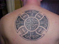 A tattoo of a solar wheel cross made out of Celtic knots and circles, both symbols for eternity