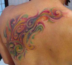An abstract tattoo design of colorful swirls and sparkling stars