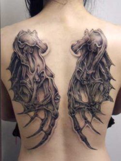 A set of demon or dragon wings make up this gothic tattoo on the back and shoulders