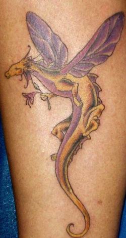 A cute cartoon dragon tattoo that depicts the fantasy dragon as having dragonfly wings
