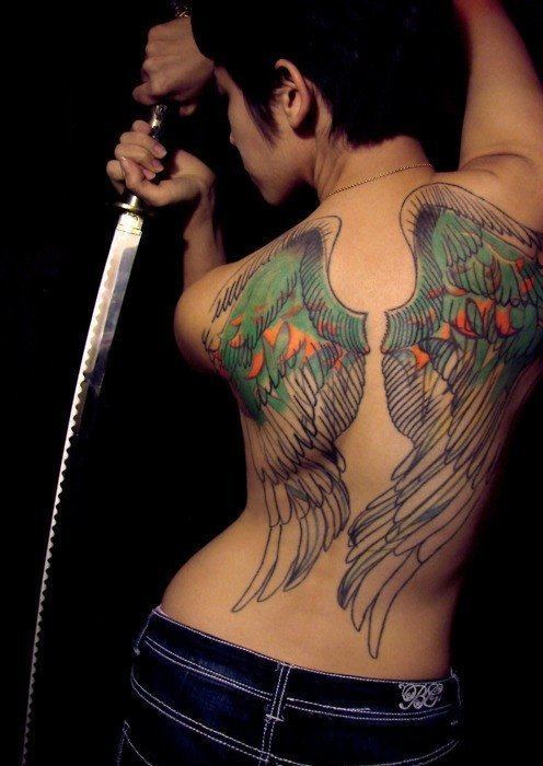 An artistic tattoo design of wings that look as though they have been drawn and painted onto the skin