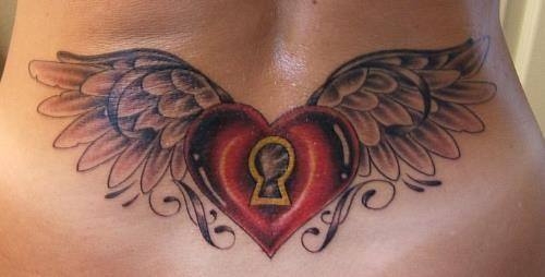 The tattoo on this girls lower back combines three powerful symbols, a heart, wings and a keyhole