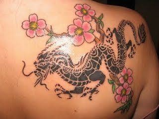 A feminine Japanese dragon tattoo with cherry blossom branches