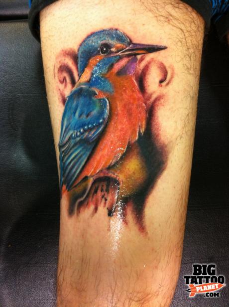 A colorful kingfisher tattoo with the meaning of determination, skill and overcoming challenge
