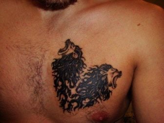 This tattoo is both a symbol of and a visual pun on the word lionheart because it uses two lions heads to make a heart