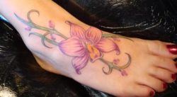 An orchid flower tattoo on the foot is a statement of beauty and femininity and looks great peeking out of summer sandals