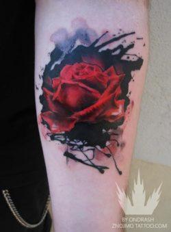 An abstract watercolor tattoo of a red rose flower by tattoo artist Ondrash