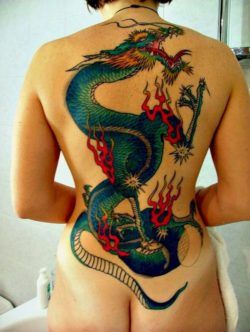 A full back dragon tattoo on a woman of an oriental dragon in traditional colors