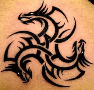 A tribal tattoo that uses three dragons heads to create a spiral design