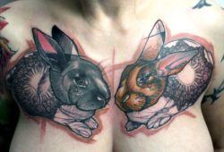 A Peter Aurisch abstract tattoo of two rabbits with hearts, mandalas and flower symbolism