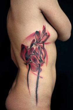 A beautiful abstract tattoo of flowers by German tattoo artist Peter Aurisch