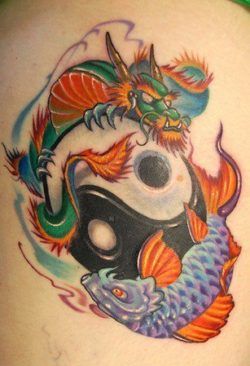 A colorful dragon and koi yin yang tattoo symbolizing balance, strength, change and success.