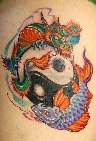A colorful dragon and koi yin yang tattoo symbolizing balance, strength, change and success.