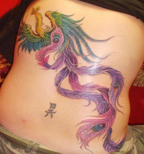 A colorful tattoo of a phoenix bird - a feminine symbol of fire and change, because the phoenix rises from the ashes of the past.