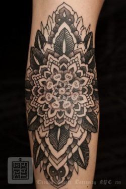 A mandala flower tattoo by Thomas Hooper that celebrates balance, harmony and beauty