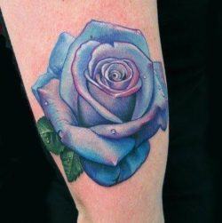A neat tattoo of a blue rose flower. Blue roses aren't natural - they are white or lavender roses that have been dyed