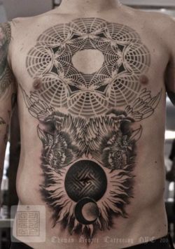 A sacred geometry tattoo by artist and designer Thomas Hooper with birds, sun and moon