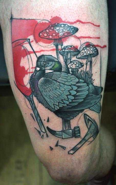 An obscure abstract tattoo art piece by German tattoo artist Peter Aurisch with a pigeon, mushrooms and tools