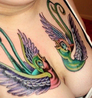 Cute, colorful and girly, this feminine tattoo design on the chest and breasts is a great choice for extroverted girls and women