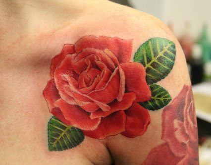 This beautiful rose tattoo on the shoulder is a symbol of love, romance and passion