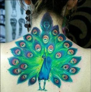 This colorful peacock bird tattoo shows of the beautiful fan tail of the male peacock during mating season