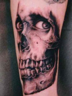 This unsettling skull tattoo combines skeletal remains with living human eyes