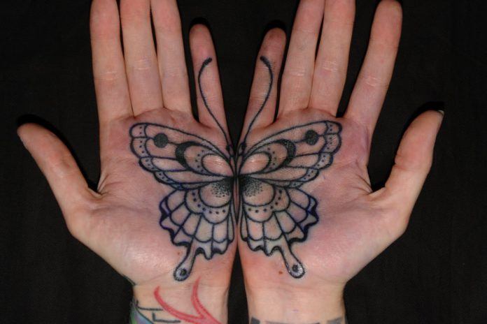 Two palm tattoos that combine to become one butterfly.