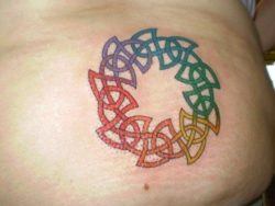 A Celtic knot tattoo in rainbow colors