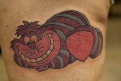 A colorful tattoo of the Cheshire Cat from the Walt Disney movie Alice in Wonderland