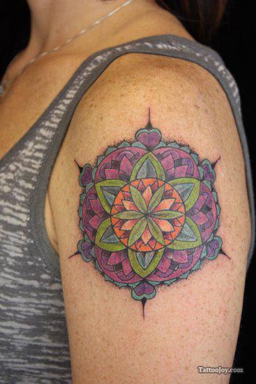 The colors and patterns of this feminine mandala tattoo create a floral effect