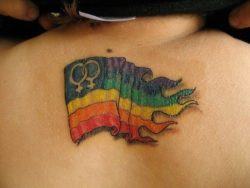 A gay lesbian flag tattoo that boasts two female symbols and bright rainbow colors