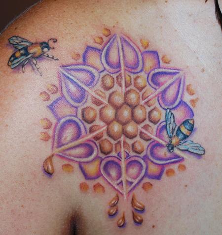 This mandala tattoo design uses honey bees and honey comb in the artwork as a symbol of the circle of life