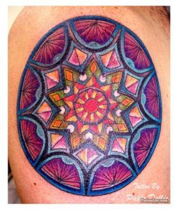 Many mandala tattoo designs resemble the colorful patterns found in the rose windows of Christian churches