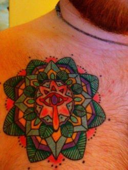 This mandala tattoo was designed for the client by the tattoo artist to surround the symbol of truth