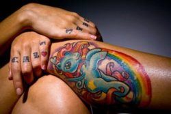A cute my little pony tattoo that shows the cartoon horse jumping over a rainbow design