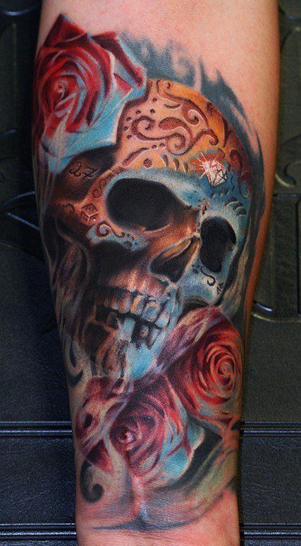 The tattoo artist has used yellow and blue lighting in this artistic sugar skull tattoo