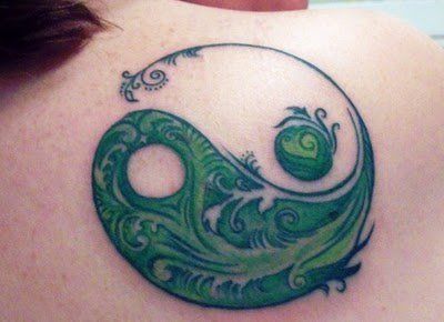 This creative yin yang tattoo design uses floral green patterns that symbolize fertility