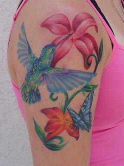 A hummingbird, butterfly and flowers make up this beautiful tattoo; a perfect tattoo design for women or girls