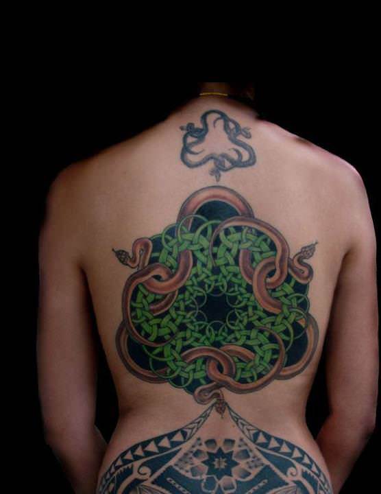 A large back tattoo of an MC Escher design that features celtic knots and snakes