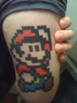 A pixel tattoo of the Nintendo video games character Mario, from the popular 1980s arcade games