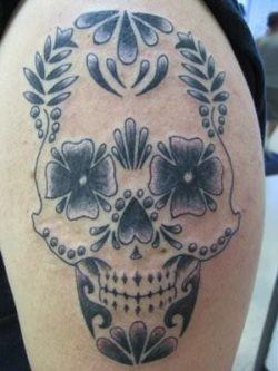 A stylized sugar skull tattoo designs with flowers instead of eyes