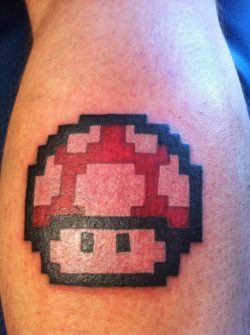 A tattoo of the 1980s magic mushroom from the Mario Nintendo games in a pixel style