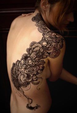 Even though this isn't lace, this delicate and decorative tattoo design is inspired by lace designs
