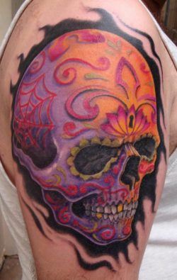 Purple, pink and yellow dominate this Day of the Dead sugar skull tattoo design